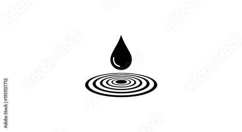 A black drop of water creating ripples.