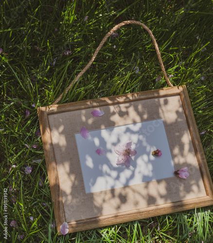 a wooden frame and flowers on the grass