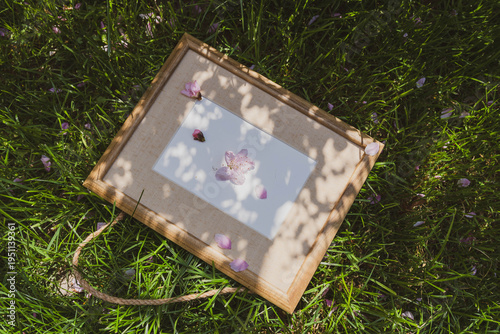 a wooden frame and flowers on the grass