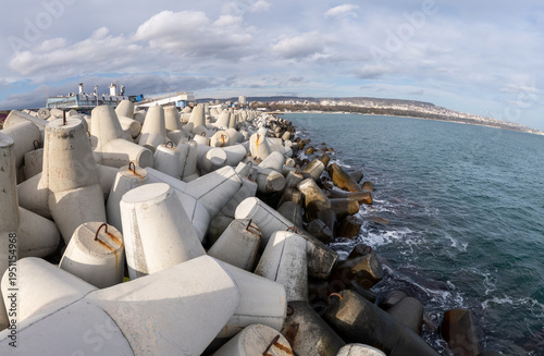 Фотография Panoramic view of a coastal breakwater constructed with concrete tetrapods