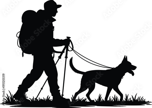 Man hiking with dog on leash in silhouette walking through grass