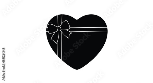 A black heart shaped gift with a bow a striking silhouette