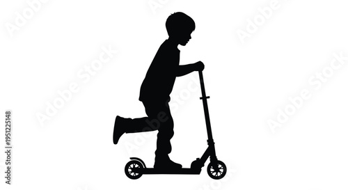 Young boy riding a scooter in a striking black silhouette