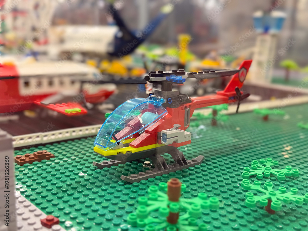 Naklejka premium Red lego helicopter on green baseplate