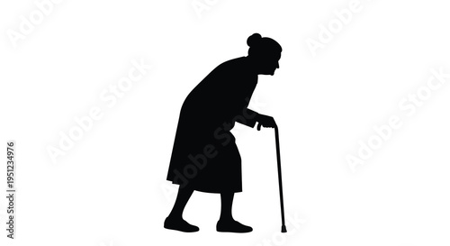 A solitary silhouette of an elderly woman bent with age slowly walking with the support of a cane