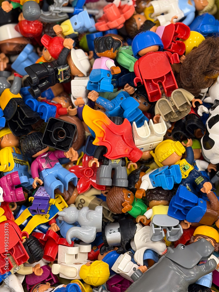 Fototapeta premium Heap of colorful toy figures and parts