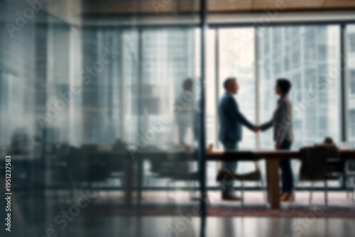Blurred Professional business partners shaking hands in modern office