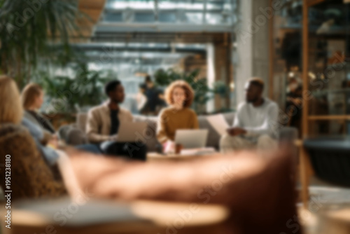 Blurred Diverse team collaborating in modern office lounge