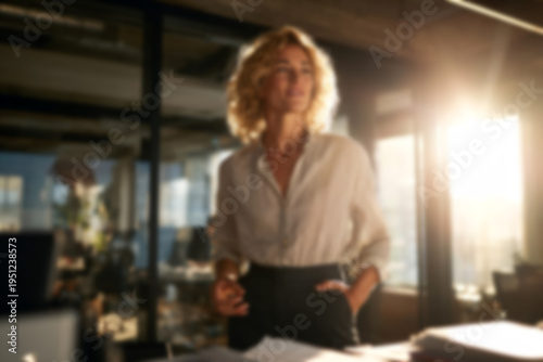 Blurred Confident businesswoman standing in modern office space