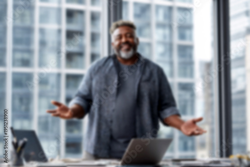 Blurred Happy businessman standing in modern office with open arms