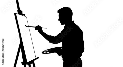 Silhouette of man painting on canvas.