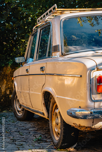 Vintage Soviet Lada car parked on cobblestone street in Kutaisi, Georgia
