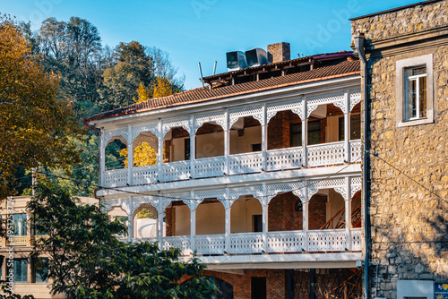 Traditional georgian house with wooden carved balcony in the street of Kutaisi, Georgia