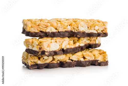 Canvas Print Stack of Chocolate-Coated Peanut Granola Bars With Nuts and Caramel on White Bac