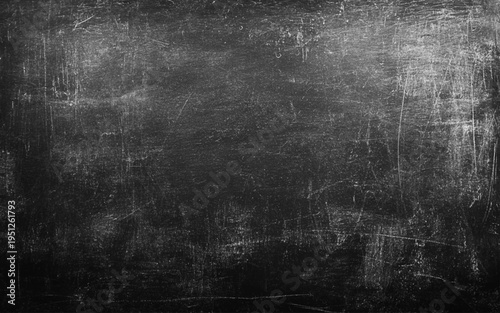 Blackboard with space to add text or graphic design. Abstract traces of rubbed out chalk on blackboard.