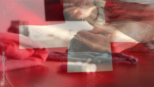 Swiss flag waving against mid section of woman sewing face mask