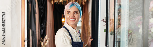 Young florist with colorful hair joyfully working in beloved shop