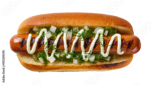 Isolated hot dog with grilled sausage in bun, topped with relish, diced onion, dill, and zigzag mayonnaise