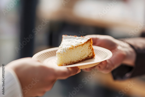 close up of a paper plate with a slice of homemade cake being handed to a smiling customer, realistic textures, soft daylight,