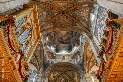 Ornate golden pipe organ and frescoed vaulted ceiling inside the majestic Parma Cathedral in Parma, Italy 06.01.2026