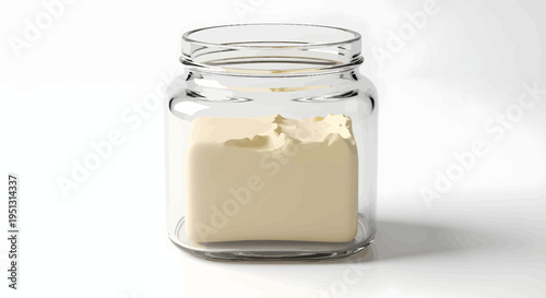 A glass jar contains butter on a white surface indoors.