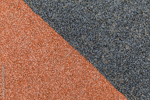Vászonkép Texture contrast: earthy orange meets dark gray granular surface