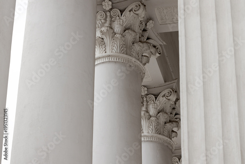 Ancient Greek temple columns with ornate Corinthian capitals and detailed carvings