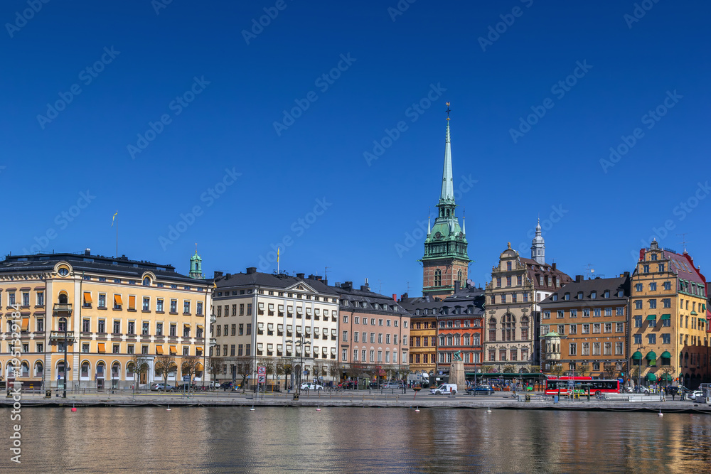 Fototapeta premium View of Kornhamnstorg square and old town colorful buildings from the water in Stockholm, Sweden. Clear blue sky in April