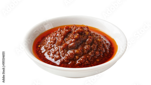 Isolated flavorful spicy chili crunch oil sauce in small white ceramic bowl for Asian food
