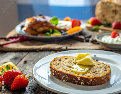 A plate of toasted bread with butter on a rustic wooden table