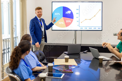 Business professional presenting financial data during meeting