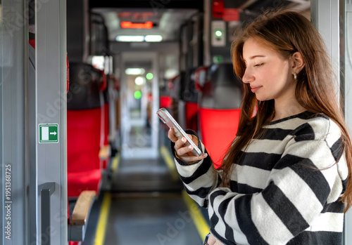 Wallpaper Mural Young Woman Stands By The Train Exit Looking At Smartphone Torontodigital.ca