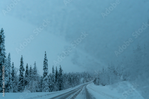 snow covered road with frozen windshield