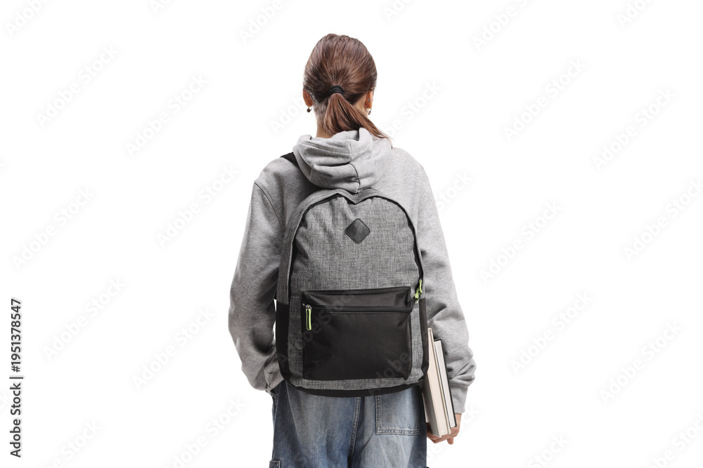 Fototapeta premium Rear view shot of a female teenage student with a backpack