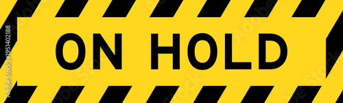 Yellow and black color with line striped label banner with word on hold