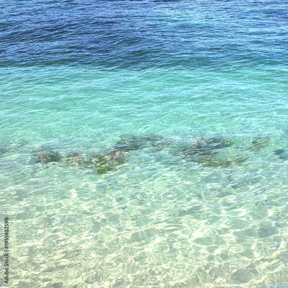 Fototapeta premium Turquoise sea water background texture with sunlight and ripple pattern