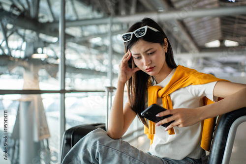 Schilderij op canvas Unhappy young woman traveler disappointed with flight delay or cancelation while waiting at airport terminal, female tourist upset after receiving bad news when sitting at airline lounge
