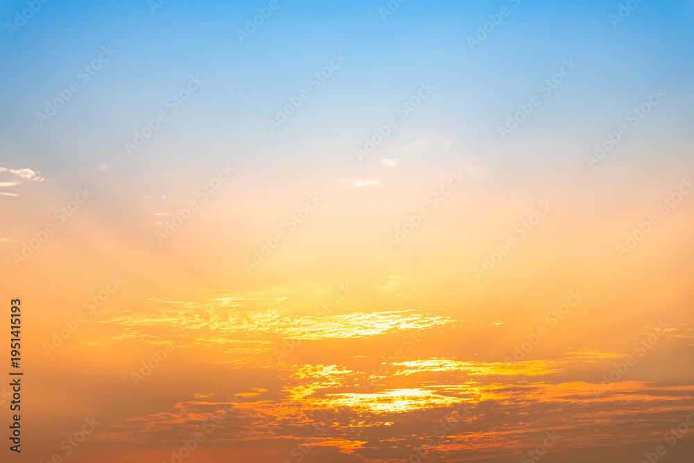 Fototapeta premium Beautiful luxury soft gradient with orange gold clouds and sunlight on the blue sky perfect for the background, take in everning,morning,Twilight, high definition landscape photo