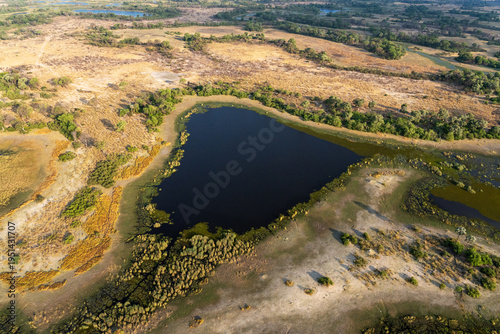 An aerial shot of a rather dry wetland in Okavango delta during an evening near Maun, Botswana