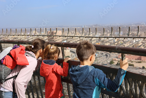 Slika na platnu Tourists looking out from the Cairo Tower observation deck, viewing the urban la