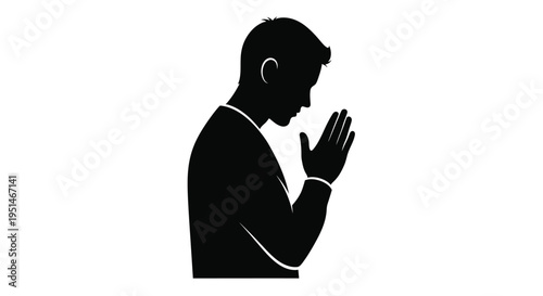 A man in a suit with hands clasped facing downwards silhouette