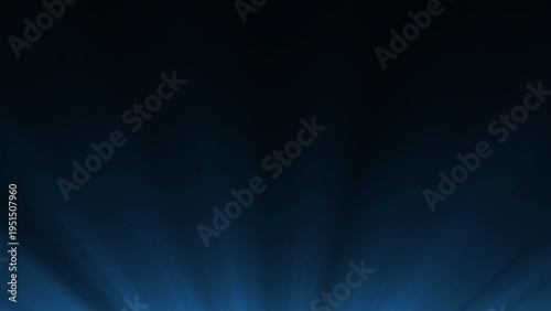 Computer generated blue spotlight rays spreading through darkness, creating a dramatic stage lighting background for concerts, theater, presentations, and abstract visual design.