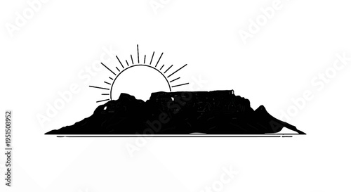 Silhouette of a flat-topped mountain at sunrise with rays