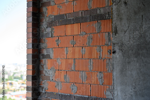 Bilde på lerret Brick wall construction with exposed mortar and concrete background