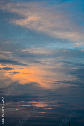 Smooth orange and blue gradient sky at peaceful twilight hour.