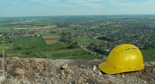 Construction estate setting with hard hat on laptop surface copy space