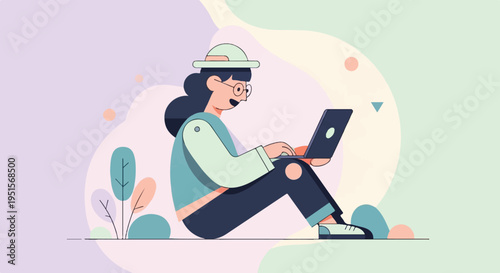 Young person wearing a hat and glasses sits using a laptop