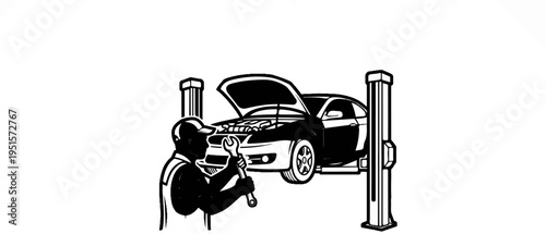 A mechanic with a wrench works on a car raised on a hydraulic lift