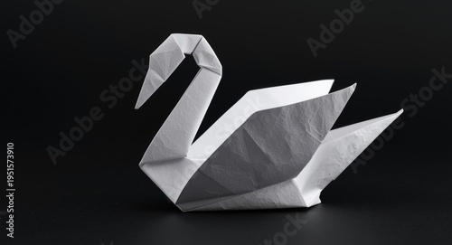An elaborate origami swan formed with careful white paper folds and textures