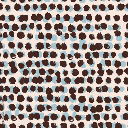 A bold seamless vector pattern of abstract organic spots in dark brown and sky blue on a warm cream background 